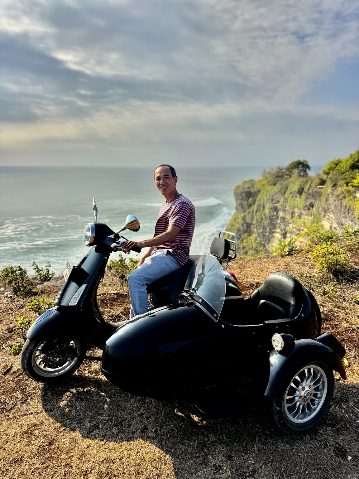 Island Sidecar Tours guide overlooking the Uluwatu coastline