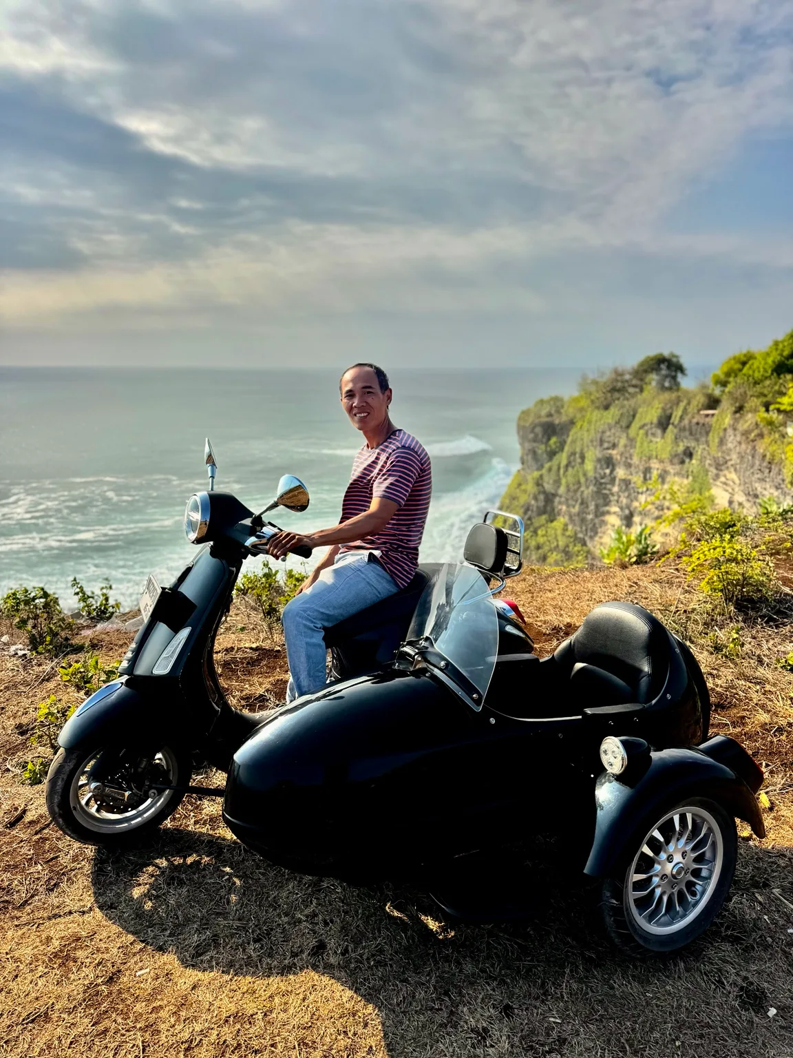 Island Sidecar Tours guide overlooking the Uluwatu coastline
