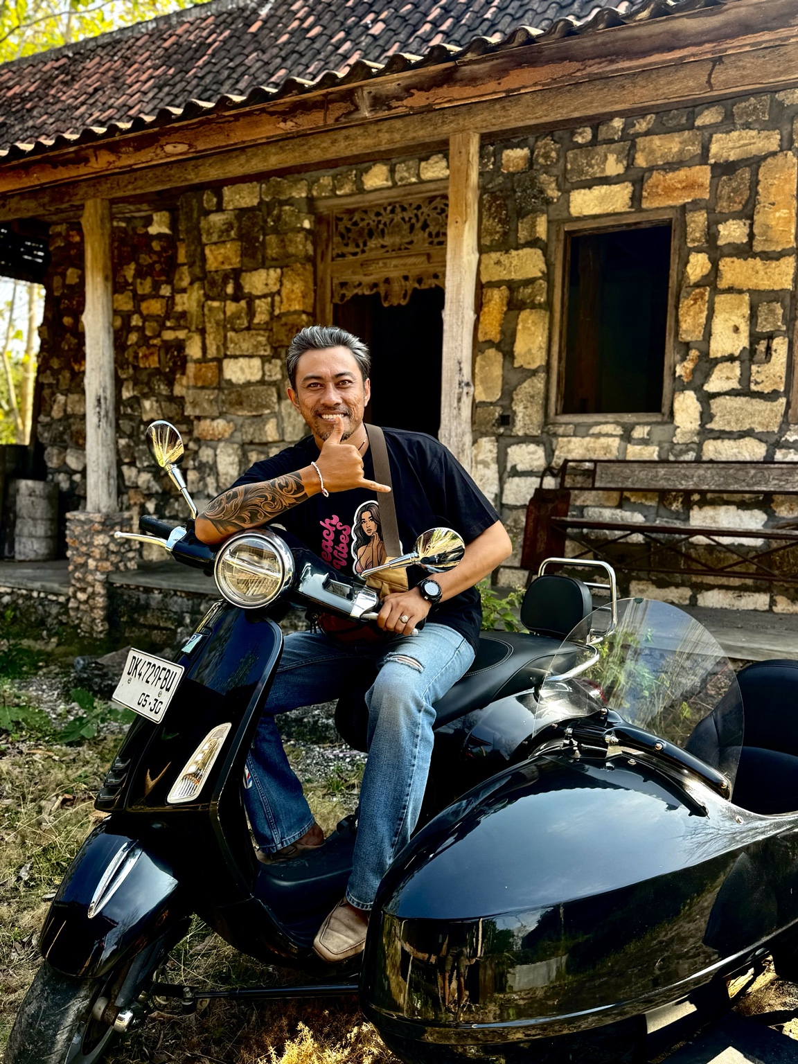 Island Sidecar Tours guide beside a traditional stone building