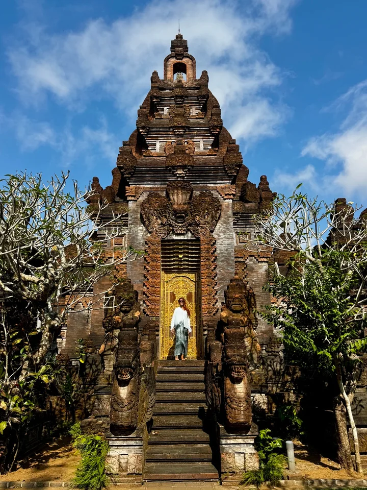 Guest exploring an ornate traditional temple doorway