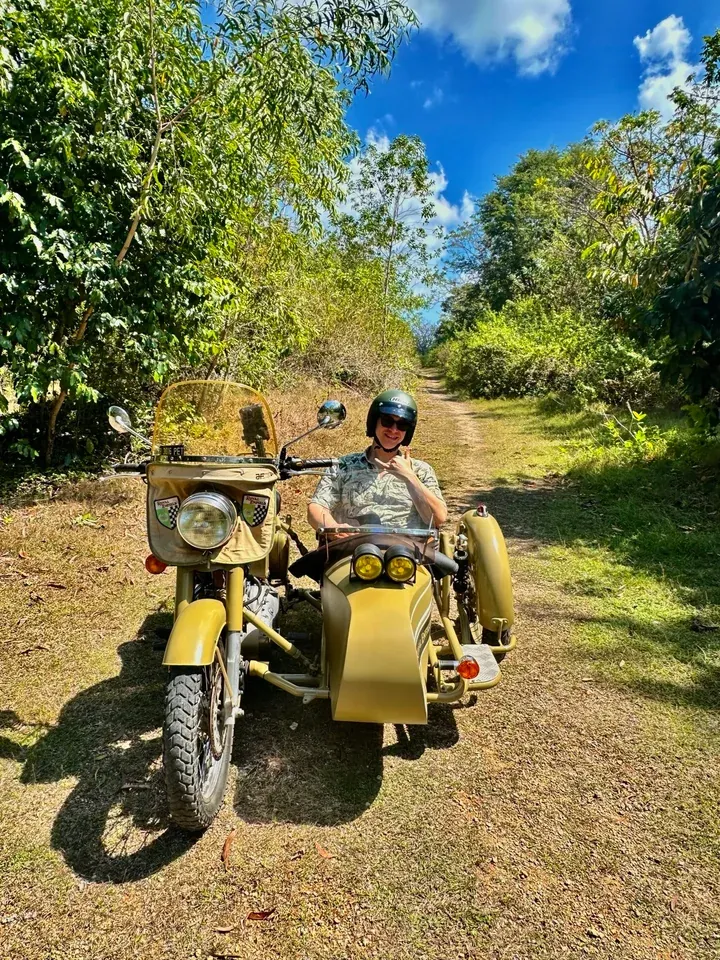 Royal Enfield sidecar on a leafy village track