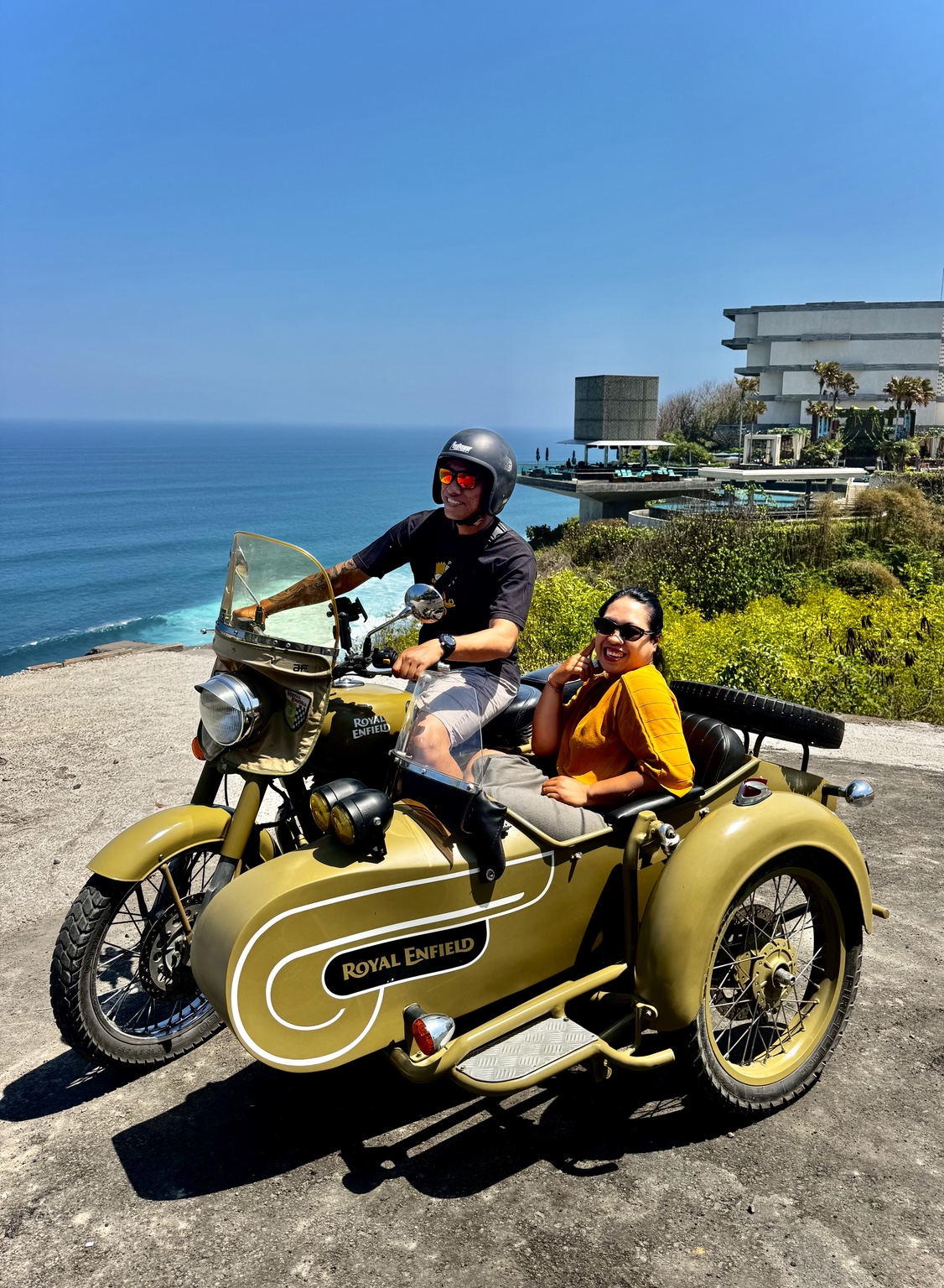 Guest enjoying the Royal Enfield sidecar with a Balinese landscape behind her